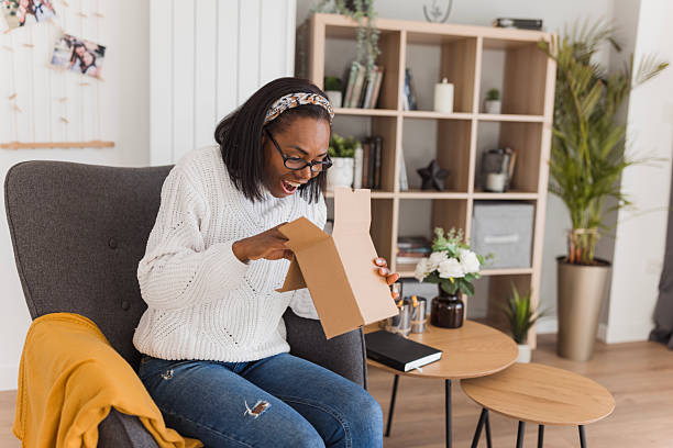 istock Curious woman opening a mystery box 2208356395