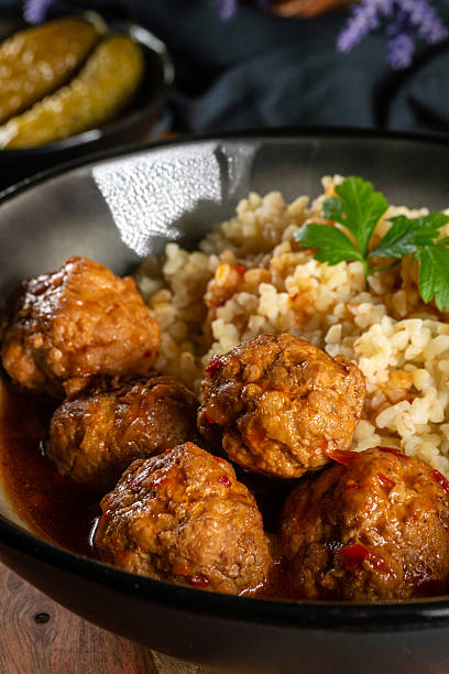 istock Meatballs pork and mashed potatoein paprika gravy served with groats bulgur. 2208357721