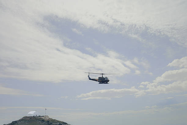 istock Huey helicopter in flight view 2208358868