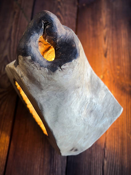 Artisan lamp made from a single piece of natural wood, featuring a hollowed-out center with an exposed filament bulb. Combining rustic charm with modern industrial aesthetics, it's perfect for eco-conscious interiors and unique design lovers.