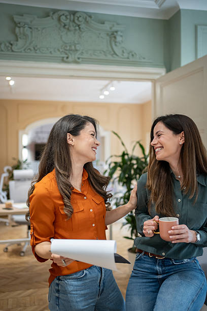 istock Two businesswomen smiling and talking during coffee break 2208364031