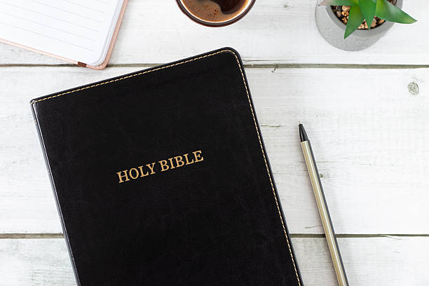 istock Top view of holy bible book with notebook and coffee cup 2208366270