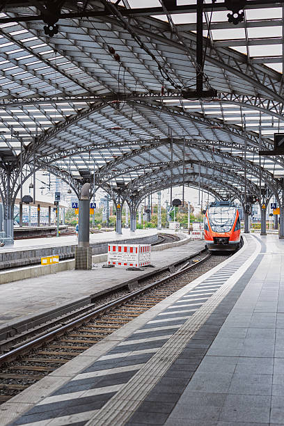 istock Red commuter train arriving on the railway station 2208370370