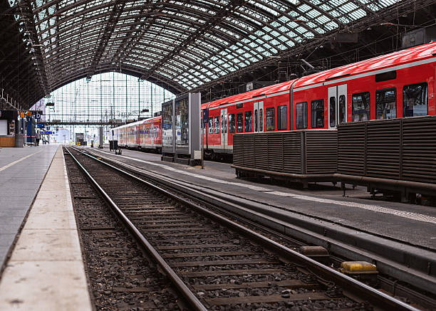 Red commuter train arriving on the railway station