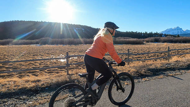istock Mature woman e-bikes along pathway in mountains 2208370650
