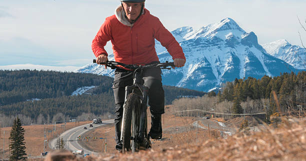 istock Mature man e-bikes in mountain meadow in winter 2208370966