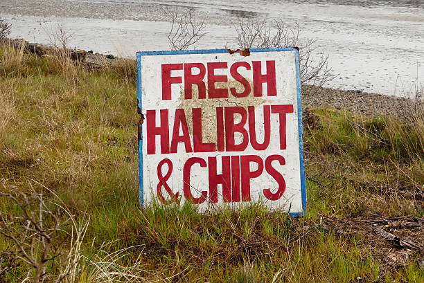 Old fish and chips sign washed up on Yaquina Bay in Newport, Oregon