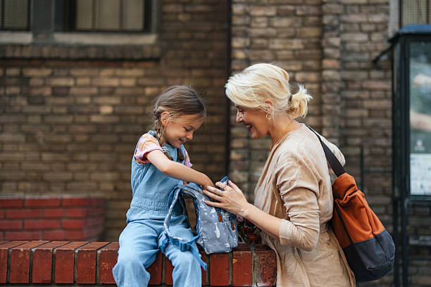 istock Happy Child and Parent Sharing a Moment on a Brick Wall 2208374671