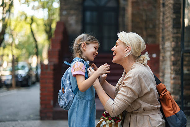 istock Mother and Daughter Sharing a Moment Before School on a Sunny Day 2208374672