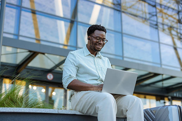 istock Cheerful professional traveler working on laptop 2208374817