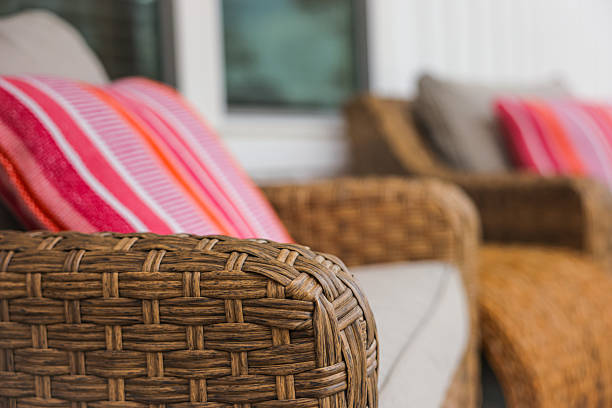 istock Wicker Chair with Vibrant Pillows on Porch 2208378791