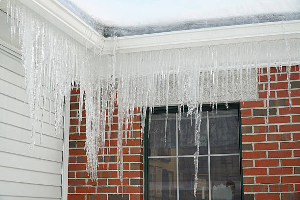 istock icicle hanging on house roof 2208379338