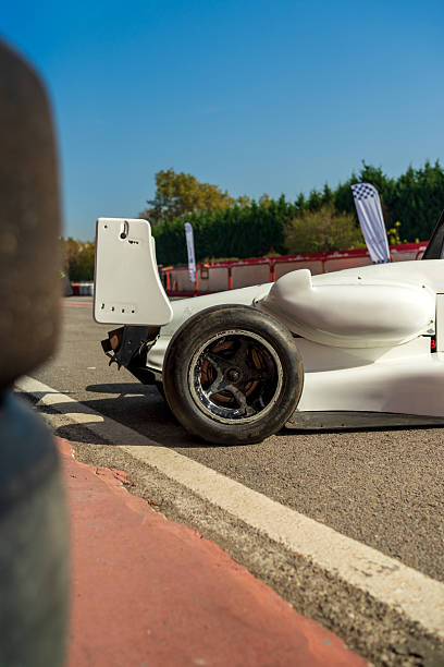 race car burns rubber off its tires in preparation for the race