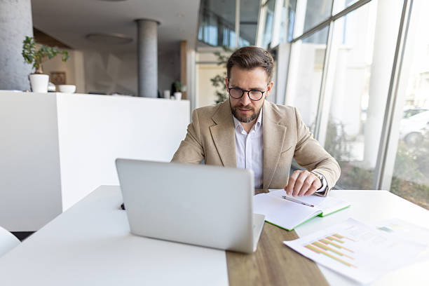 istock Business Professional Engaging with Laptop in Modern Office 2208402330