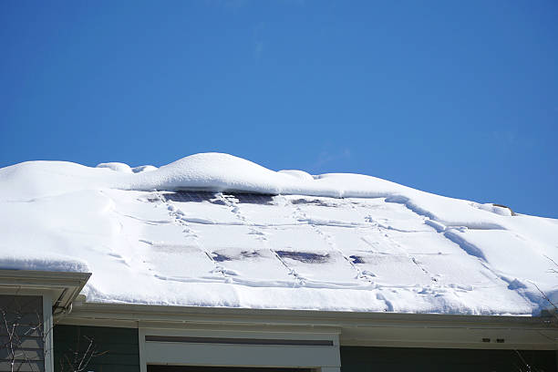 istock solar panel on the roof covered by snow after blizzard in winter 2208402807