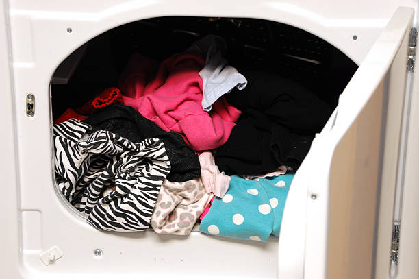 close up on dryer with clothes in and door open