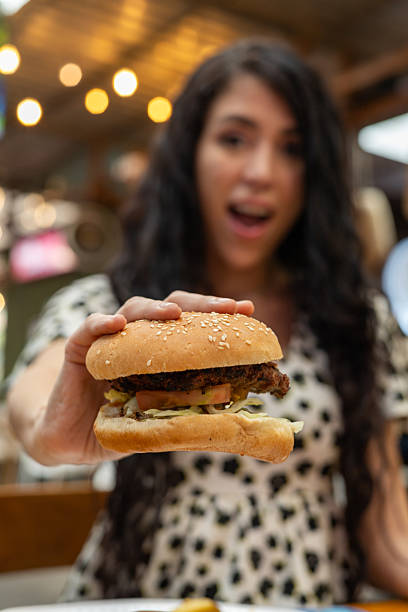 istock Looking at Her Burger with Wonder and Excitement 2208409084