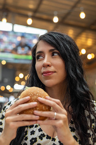 istock Joyful pause before the first bite of her juicy burger 2208409381