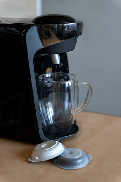 istock Home capsule coffee maker for aromatic coffee. Capsule coffee maker with glass cup for latte and capsules for preparation in home kitchen. 2208409398
