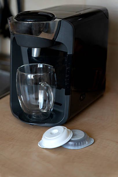 istock Capsule coffee maker with glass cup for latte and capsules for preparation in home kitchen. Home capsule coffee maker for aromatic coffee. 2208409407