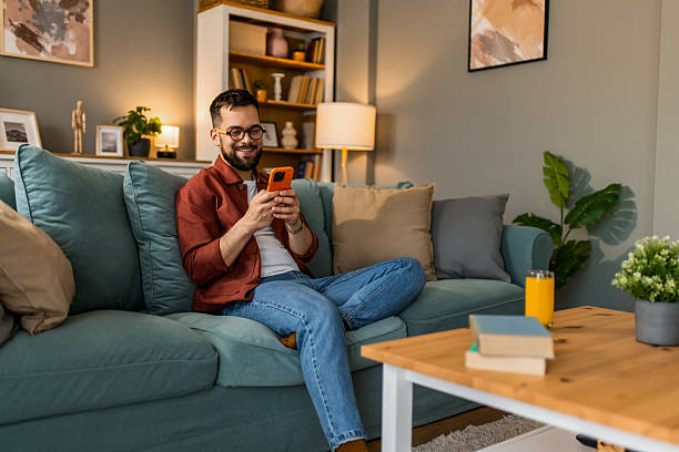 istock Young man relaxing at home and using smart phone at home. 2208411651
