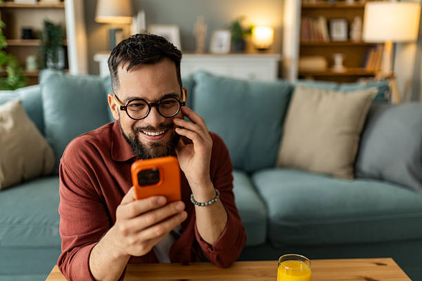 istock Young man relaxing at home and using smart phone at home. 2208412841