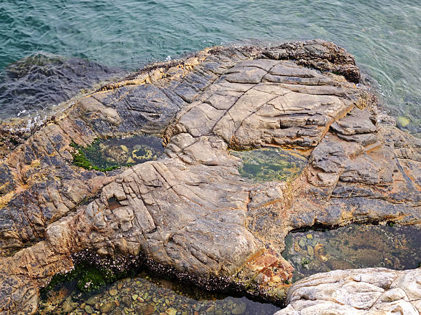 Rocks at Deep Water Bay. The bay is located on the southern shore of Hong Kong Island in Hong Kong. The bay is surrounded by Shouson Hill, Brick Hill, Violet Hill and Middle Island.