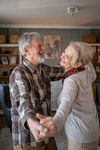 istock Happy senior couple dancing together at home 2208417401