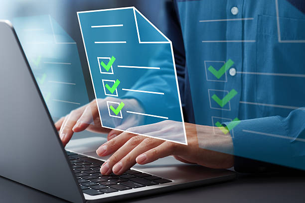 istock Legal document management and preparation. File icons and checkmark. Compliance system. Hands typing on laptop computer keyboard. Businessman working at desk in office. 2208418112