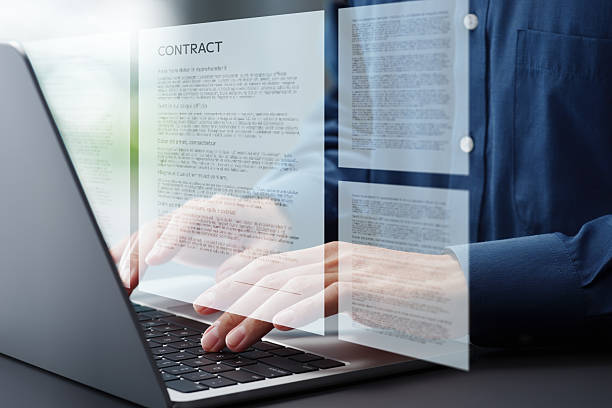 istock Preparing contract agreement or document. Hands typing on laptop computer keyboard. Businessman working at desk in office. 2208418118