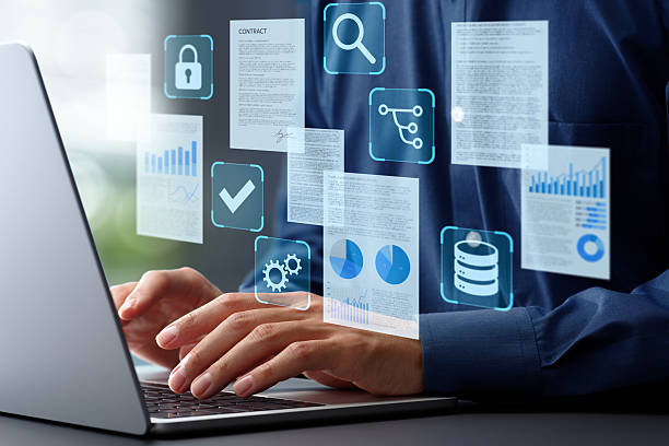 istock Document management system DMS in business. OR enterprise contents management ECM. Hands typing on laptop computer keyboard. Businessman working at desk in office. 2208418164