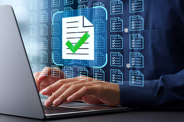 istock Legal document management system. Automation of preparing documents. File icon and checkmark. Businessman typing on laptop computer keyboard at desk in office. 2208418178