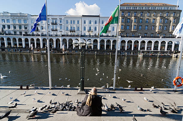 HAMBURG, GERMANY - SEPTEMBER 26: Unknown man in the historic center at town canal 'Kleine Alster' on September 26, 2013 in Hamburg, Germany