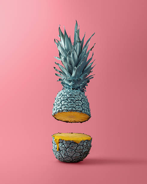 istock Visually striking floating pineapple with metallic peel and a drip of juice in a creative surreal composition on pink backdrop. 2208419675