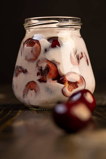 istock fresh cow's cream yogurt with cherry flavor and berry slices 2208419902