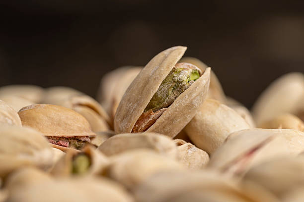 istock a bunch of cracked pistachios with green nuts inside 2208420575