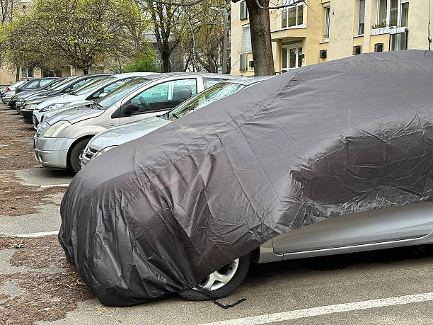 istock Car under protective cover in the parking lot 2208422710