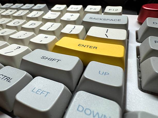 Large yellow Enter button in English on mechanical white keyboard for programmers with gray shades and red switches right side view