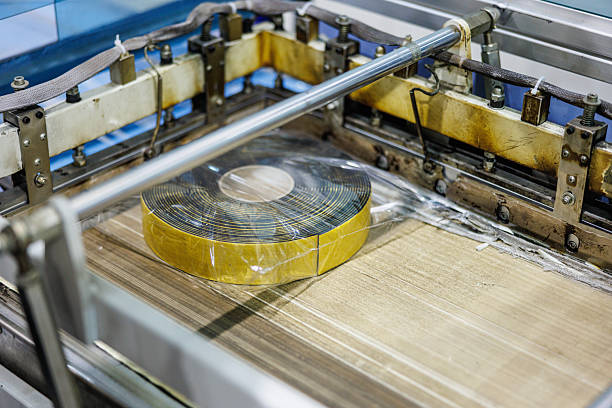 Electrical insulation tape roll packed coming out of the conveyor machine, small business manufacturing and warehouse