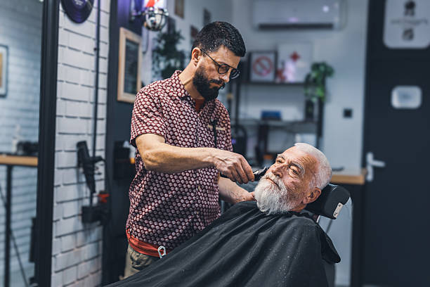 istock Senior man cutting his beard in barbershop 2208427915