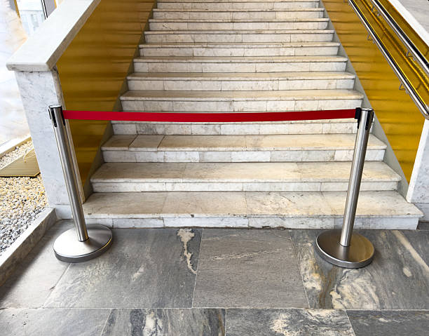 istock A red rope is on the steps of a staircase 2208429490