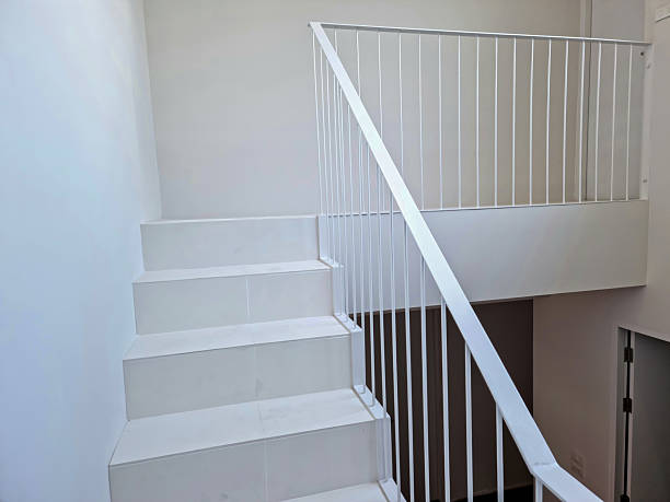 istock White wooden staircase frame on abstract background 2208431190