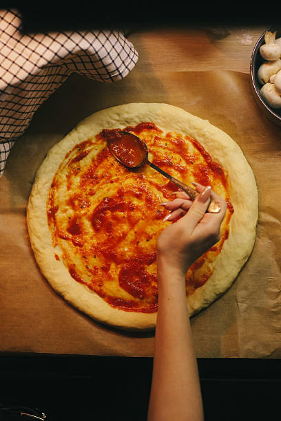 istock Making Homemade Pizza with Tomato Sauce 2208431655