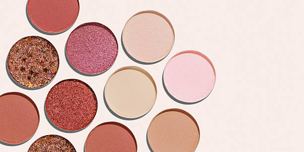 istock Banner with Cosmetics texture pattern, Warm vivid colored eye shadow makeup palette, round eye powder swatches. Female cosmetic, beauty products, aesthetic beauty photo, colorful eyeshade, top view 2208432628