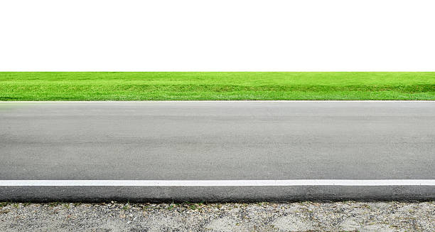istock Asphalt road leading to green grass field with white background 2208434024