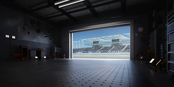 istock 3D Racing track seen from inside a garage with open roller door 2208434096