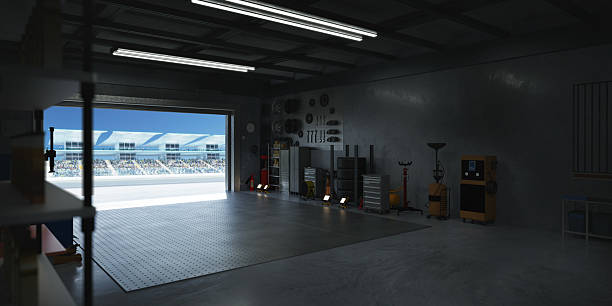 istock 3D Motorsport pit garage overlooking empty race track with spectators waiting 2208434097