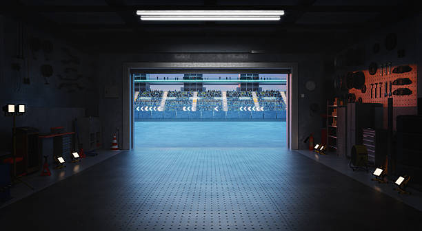 istock 3D Garage opening onto a stadium with spectators waiting for a race to start 2208434104