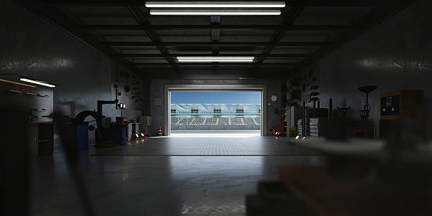 istock 3D Motorsport workshop overlooking race track with open roller door 2208434108