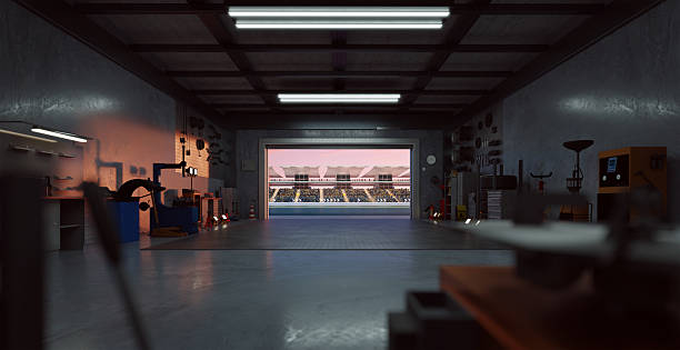 istock 3D Garage opening onto stadium with open roller door at sunset 2208434794